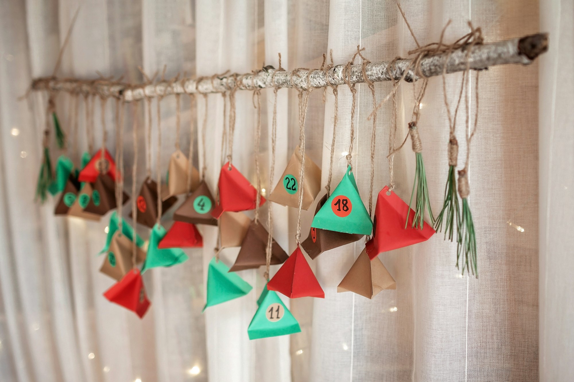 Handmade advent calendar with color paper triangles. Seasonal activity for kids