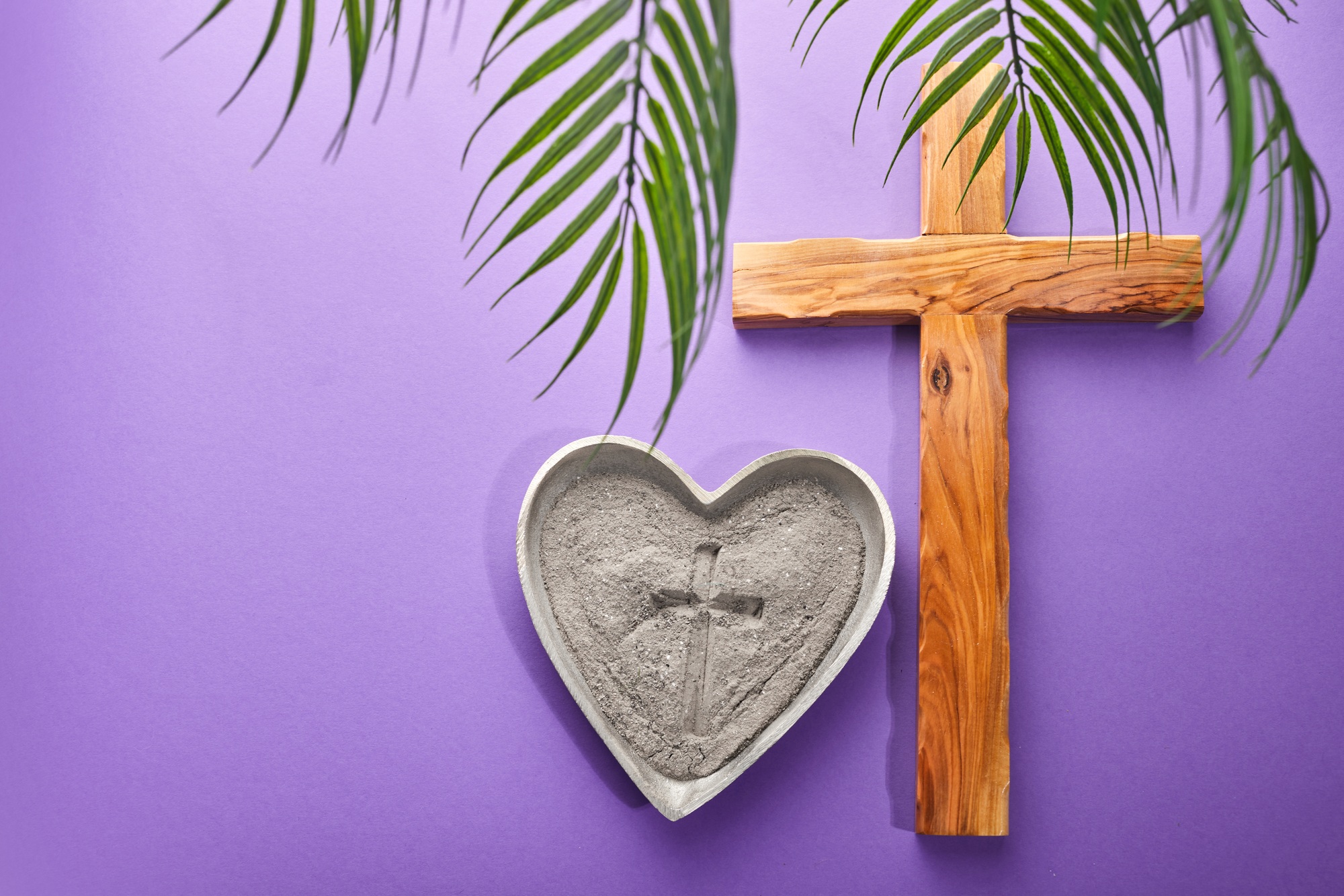 Ash Wednesday, Lent Season and Holy Week concept. Christian crosses and ashes on purple background.